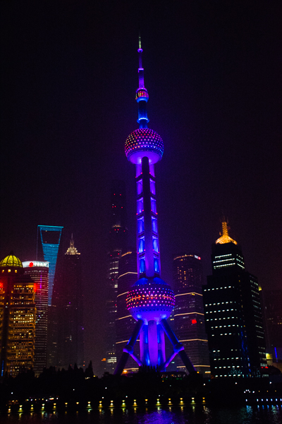 Oriental Pearl Tower at night seen from river cruise ship.