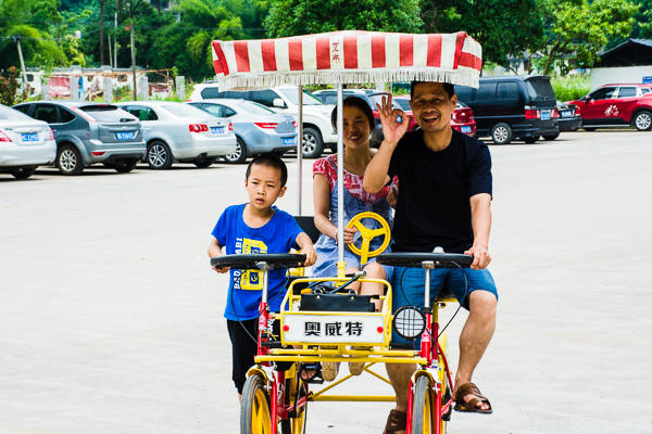 Family in their motorized vehicle seen on walk.