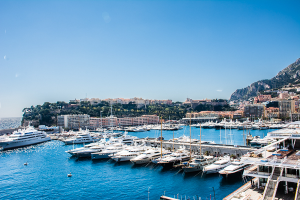 Yachts docked at Monaco with view towards The Rock.