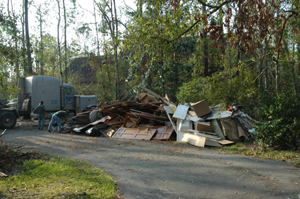 Destroyed things stacked on the street for garbage pickup.